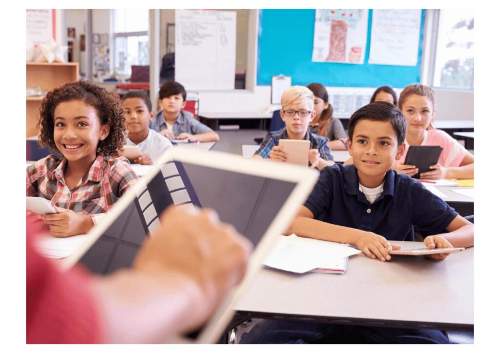 Teacher using tablets in a classroom with AInara best AI tools for educational materials